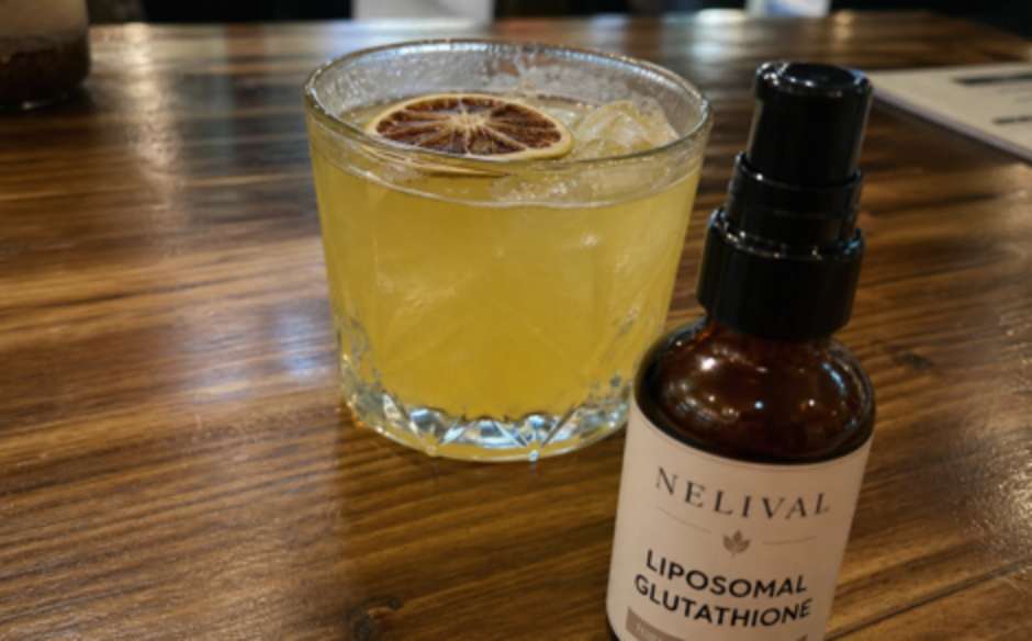 Nelival Liposomal Glutathione bottle beside a daily drink